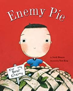 The cover of "enemy pie". A cartoon boy sits atop a latice work pie top. Leaves, caterpillars and bugs are crawling in the pie