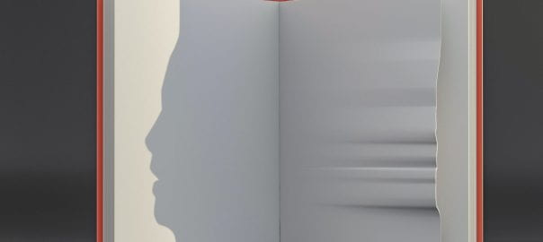 Picture of a book with the shadow of a face on one page, indenting the other page.